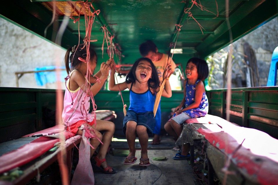 Joyful Kids enjoying themselves inside a Jeepney in Cebu City Philippines. Their smiles make me feel peaceful and joyful. I think this is pure happiness for them. copy Mac KwanNational Geographic Traveler Photo Cont